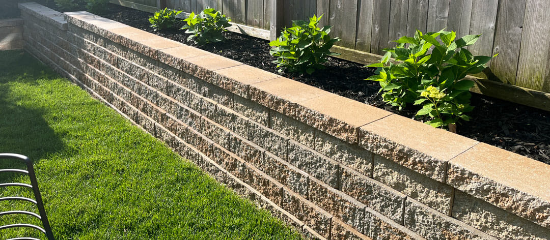 Support retaining wall on sloped yard